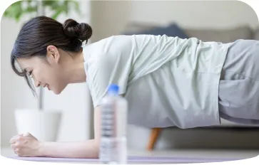 自宅で腰痛改善のストレッチをする女性の様子